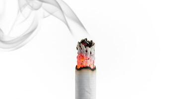 A burning cigarette isolated on white photo