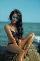 Beautiful brunette enjoying a sunny day at the seashore while exploring body epilation techniques and skincare photo
