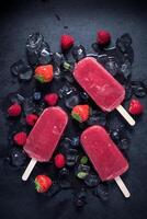 Popsicles with berries and ice on a black background photo