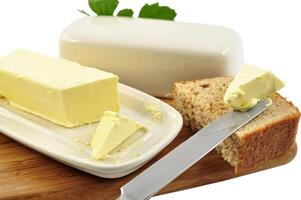 Butter on a cutting board with a knife photo
