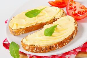 A plate topped with two slices of bread with butter photo