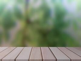 Empty Wooden Table with Blurred Green Nature Background photo