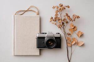 Vintage Camera, Dried Flowers, and a Blank Book A Still Life Photography Composition. Perfect for blogs, websites, and social media, evoking feelings of nostalgia and creativity. photo