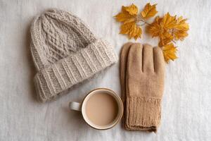 Cozy Autumn Vibes Knitted Hat, Gloves, and a Warm Drink. Perfect for a relaxing fall day at home. Enjoy the simple pleasures of th photo