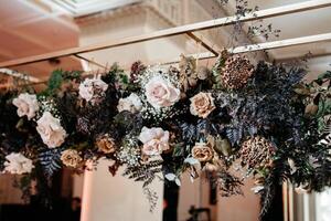 Elegant floral installation with roses and ferns in luxurious indoor setting photo