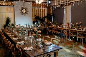 Elegant rustic wedding reception with floral arrangements and ambient lighting photo
