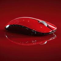 Stylish red wireless mouse resting on a reflective surface with a sleek design photo
