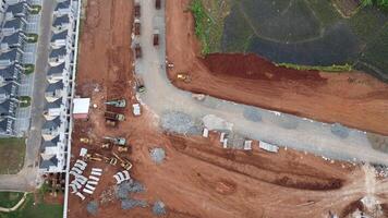 An aerial view of a construction site with a road and houses photo