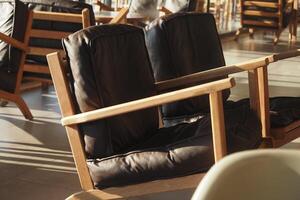 Comfy wooden chairs in a modern cafe setting photo