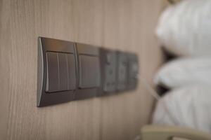 Light switches and power outlets in a cozy bedroom setting photo