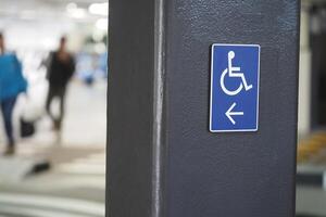 Parking sign indicating accessible space in busy area photo