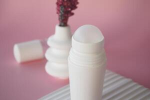 Minimalist Deodorant Bottle on Textured Surface with Soft Pink Background photo