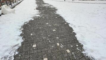 Snow covered pathway leads through a winter landscape photo
