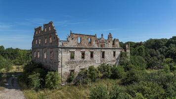 Half-ruined ancient castle, German building in Poland, Mietkow, Borzygnev. Drone view photo