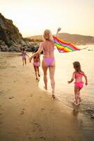 Joyful family fun under the warm sunset at the beach photo
