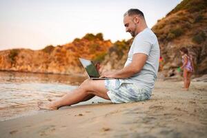 Family enjoys playful moments by the serene beach at sunset photo