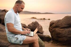 Enjoying work and family time at the beach during sunset glow photo