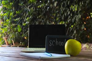 Back to school concept.There is a laptop and a school sign on the table. photo