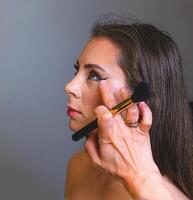 Radiant skin and bright red lips create a classic beauty look. She poses with elegance and grace photo