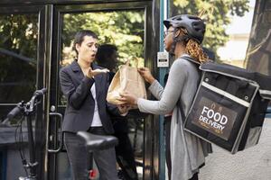 Frustrated customer holding a takeaway bag with the wrong order, confronting the delivery person about a shipping problem. The incorrect meal causes tension during this failed delivery service. photo