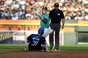 Seattle Mariners second baseman Jorge Polanco (7) turns a double play over sliding Detroit Tigers left fielder Riley Greene (31) in the second inning at Comerica Park. editorial_image