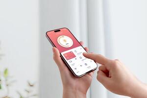 User adjusting room lighting through smartphone interface with modern smart home technology photo