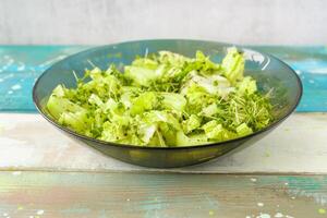 Fresh microgreen salad on a transparent bowl. A natural and organic concept for healthy eating and spring or summer food presentations. photo