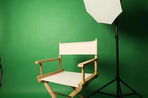 Chair of Film Director. Directors chair in green screen studio setup with softbox lighting. Ideal for filmmaking production photo interviews and creative content with green chroma key background