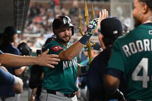 Seattle Mariners designated hitter Cal Raleigh (29) celebrates in the dugout after hitting a grand slam home run against the Detroit Tigers in the ninth inning at Comerica Park. editorial_image