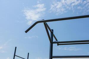 Gymnastics equipment stands tall against the blue sky, inviting athletes to engage in strength training and active exercise routines photo