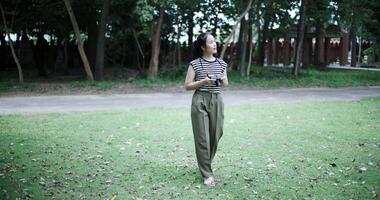 Handheld shot, Happy young woman is enjoying a quiet walk while taking pictures of the surrounding nature, Enjoy travel. video