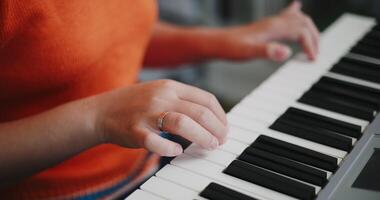 Close up shot, Woman's hands are practicing playing the piano keyboard with relaxation and happiness in the living room. video