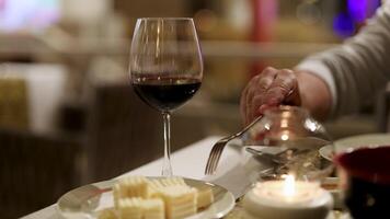 A refined dining scene featuring wine and cheese, with warm lighting and a focus on culinary enjoyment video