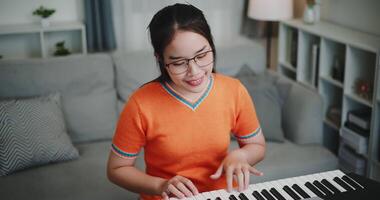 High angle view shot,Determined young woman is practicing her keyboard alone and enjoys a peaceful moment with music. video