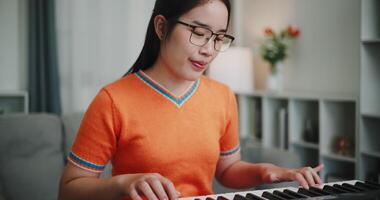 Selective focus shot, A determined young woman is practicing her keyboard alone and enjoys a peaceful moment with music. video