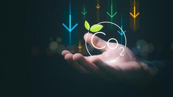 The concept of reducing global climate change, reducing global warming, a man is showing the reduction of CO2, which is the main cause of greenhouse gases and causes global warming. photo