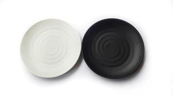 Empty circle white and black plates with ceramic melamin material isolated on white background photo