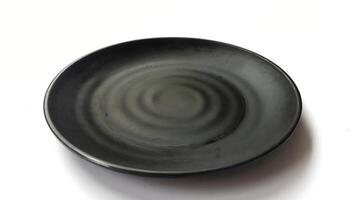 Empty circle black plate with ceramic melamin material isolated on white background photo