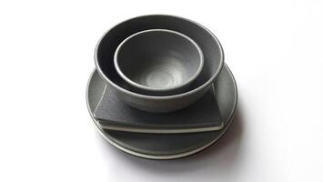 Stack of empty circle grey bowls and empty white grey square plates with ceramic melamin material isolated on white background. Clipping path photo