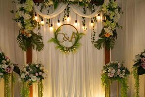 a wedding ceremony with flowers and greenery photo