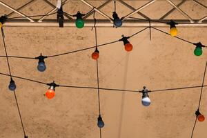 Colorful decorative lights create a festive atmosphere under a tent during an evening gathering in a warm summer setting photo