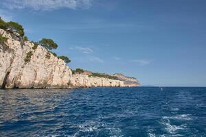 Water wake behind a moving boat off the Calanques of Marseille, a symbol of adventure and freedom in the Mediterranean photo