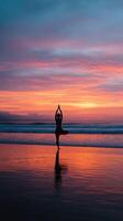 Yoga pose at sunset on beach photo