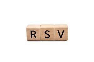RSV, Respiratory Syncytial Virus, Abbreviation on Wooden Blocks isolated on white background with clipping path. ideal for conveying topics related to health, disease, prevention, medical research. photo
