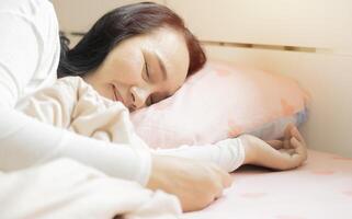 Side view close-up portrait of attractive shine healthy dreamy aged woman lying in bed sleeping silence photo