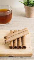 Chocolate rolled snacks on wooden board photo
