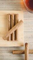 Chocolate rolled cookies on a wooden plate photo