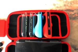 Nintendo Switch Game Console Oled in Black Red Top View photo