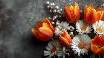 A bouquet of bright orange tulips and snow-white daisies with a yellow center stands out effectively against a dark gray background, creating a harmonious floral composition. photo