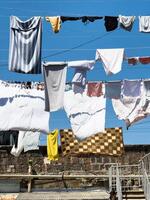 A line of clothes hanging on a clothesline photo